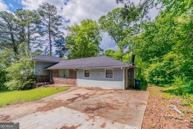 1956 Joseph Ct, Decatur, GA 30032 - tri-level home with brick siding, a front lawn, and concrete driveway