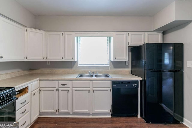 1956 Joseph Ct, Decatur, GA 30032 - kitchen featuring white cabinets, a sink, light countertops, dark wood-type flooring, and black appliances