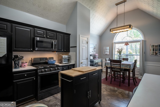 344 River Landing Dr, Monroe, GA 30656 - kitchen with stainless steel microwave, range with gas cooktop, dark cabinetry, lofted ceiling, and butcher block countertops