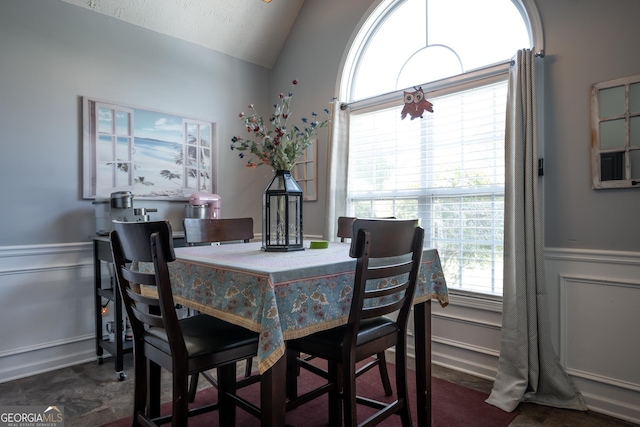 344 River Landing Dr, Monroe, GA 30656 - dining space featuring healthy amount of natural light, vaulted ceiling, wainscoting, and a decorative wall