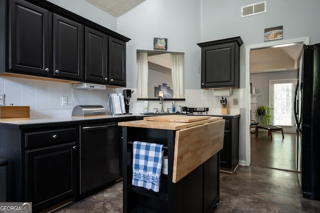 344 River Landing Dr, Monroe, GA 30656 - kitchen with dark cabinetry, wooden counters, black appliances, a center island, and a sink