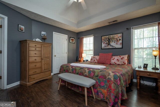 344 River Landing Dr, Monroe, GA 30656 - bedroom featuring dark wood finished floors, a tray ceiling, baseboards, and ceiling fan
