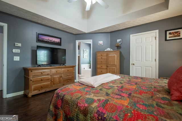 344 River Landing Dr, Monroe, GA 30656 - bedroom featuring dark wood-style flooring, a raised ceiling, baseboards, ensuite bathroom, and ceiling fan