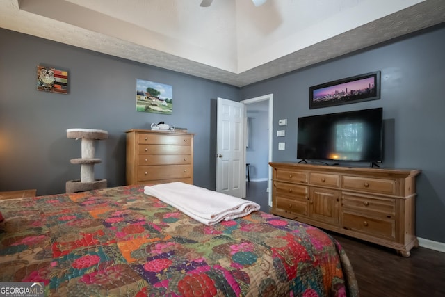344 River Landing Dr, Monroe, GA 30656 - bedroom with dark wood finished floors, baseboards, a ceiling fan, and a tray ceiling