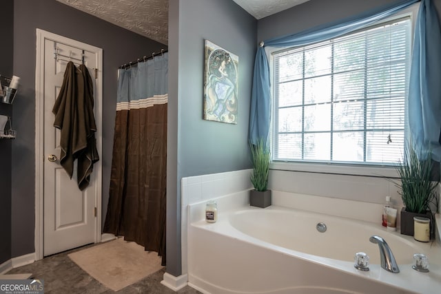 344 River Landing Dr, Monroe, GA 30656 - bathroom featuring a garden tub, plenty of natural light, and curtained shower