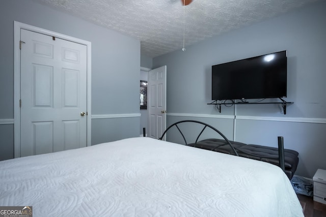 344 River Landing Dr, Monroe, GA 30656 - bedroom with wood finished floors and a textured ceiling