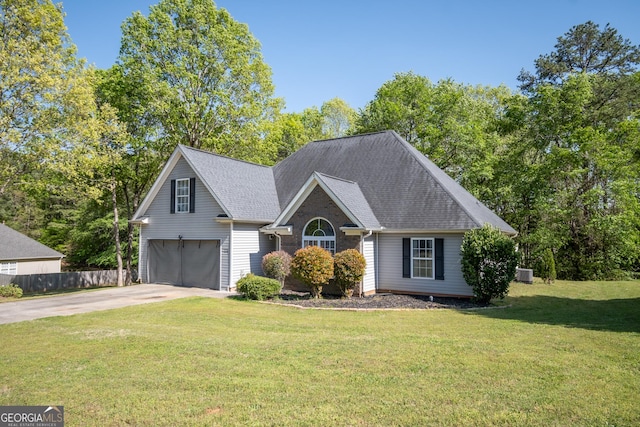 344 River Landing Dr, Monroe, GA 30656 - view of front of property featuring driveway, an attached garage, central air condition unit, and a shingled roof