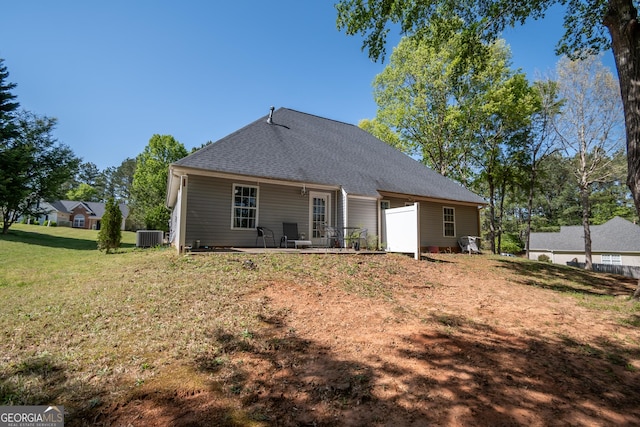 344 River Landing Dr, Monroe, GA 30656 - back of property featuring a shingled roof, a yard, central AC unit, and a patio area