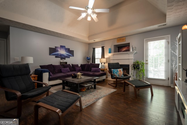 344 River Landing Dr, Monroe, GA 30656 - living area featuring a raised ceiling, wood finished floors, a ceiling fan, and a glass covered fireplace