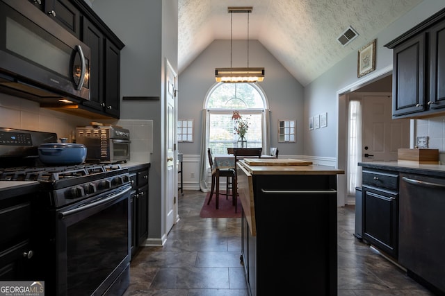 344 River Landing Dr, Monroe, GA 30656 - kitchen featuring range with gas stovetop, dishwasher, a kitchen island, a chandelier, and tasteful backsplash