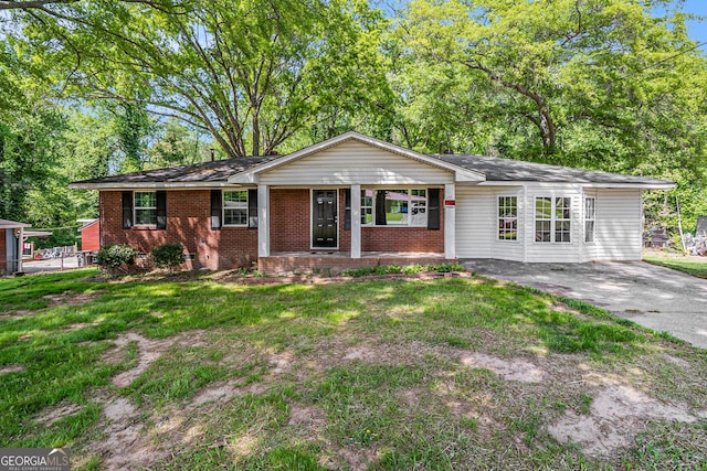 1132 Luther Dr SW, Mableton, GA 30126 - ranch-style house with brick siding, a front yard, driveway, and covered porch