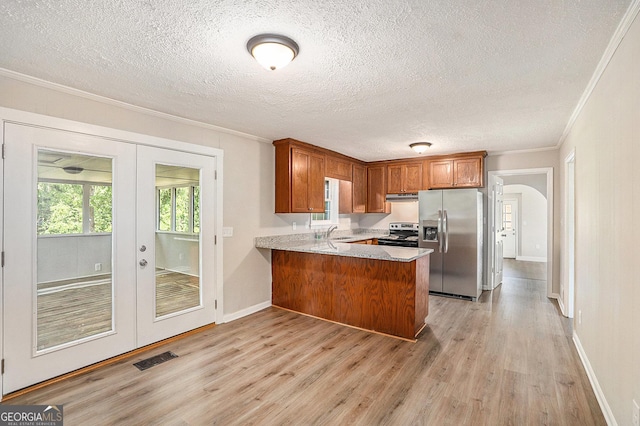 1132 Luther Dr SW, Mableton, GA 30126 - kitchen featuring crown molding, french doors, light wood-style flooring, a peninsula, and appliances with stainless steel finishes
