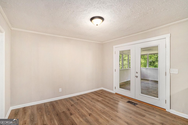 1132 Luther Dr SW, Mableton, GA 30126 - empty room with crown molding, french doors, wood finished floors, and visible vents