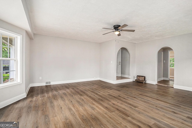 1132 Luther Dr SW, Mableton, GA 30126 - empty room featuring arched walkways, a ceiling fan, wood finished floors, and visible vents