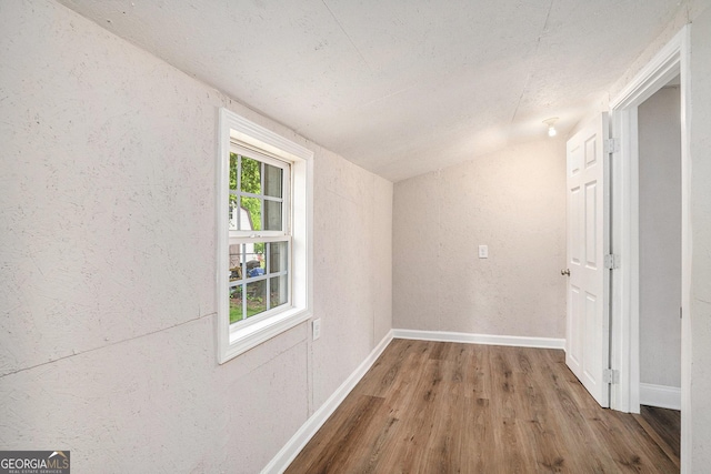 1132 Luther Dr SW, Mableton, GA 30126 - interior space with lofted ceiling, a textured wall, baseboards, and wood finished floors