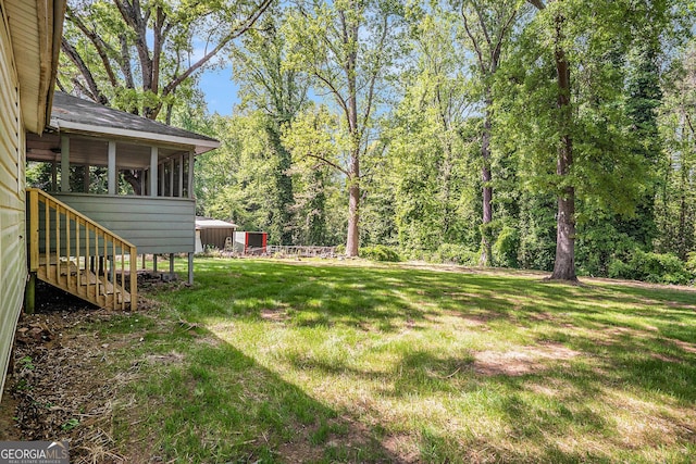 1132 Luther Dr SW, Mableton, GA 30126 - view of yard featuring a view of trees, a sunroom, and stairway
