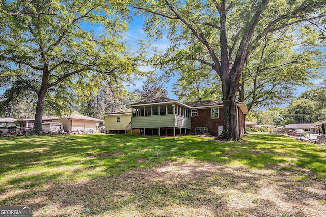 1132 Luther Dr SW, Mableton, GA 30126 - rear view of house with a yard and a sunroom