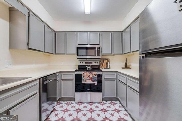 33 Hidden Lake Ct, Savannah, GA 31419 - kitchen featuring appliances with stainless steel finishes, gray cabinets, light floors, and light countertops