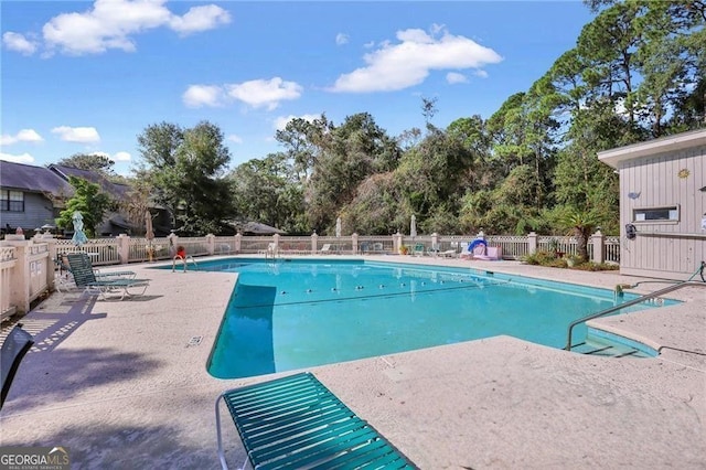 33 Hidden Lake Ct, Savannah, GA 31419 - community pool with a patio area and view of wooded area