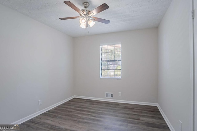 842 Brighton Dr, Lawrenceville, GA 30043 - empty room featuring baseboards, dark wood-type flooring, visible vents, and a textured ceiling