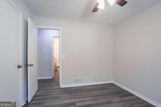 842 Brighton Dr, Lawrenceville, GA 30043 - spare room featuring dark wood finished floors, baseboards, a ceiling fan, and visible vents