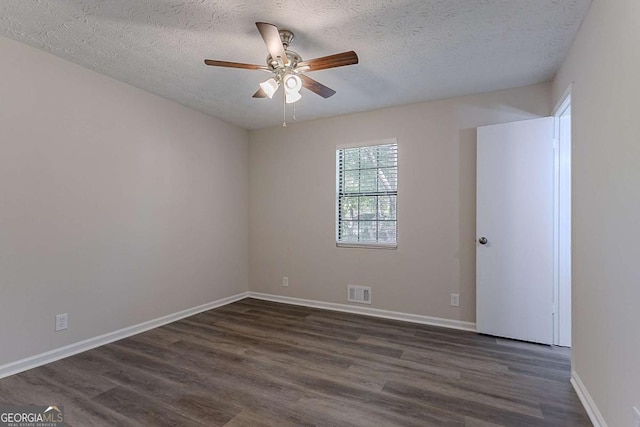 842 Brighton Dr, Lawrenceville, GA 30043 - spare room with a ceiling fan, dark wood-type flooring, visible vents, and a textured ceiling