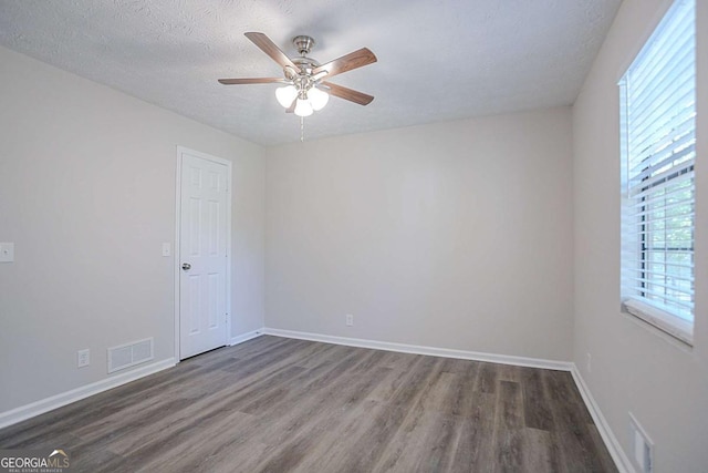 842 Brighton Dr, Lawrenceville, GA 30043 - empty room with wood finished floors, visible vents, and a ceiling fan
