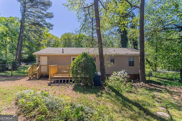 842 Brighton Dr, Lawrenceville, GA 30043 - rear view of property featuring a wooden deck, fence, and a yard