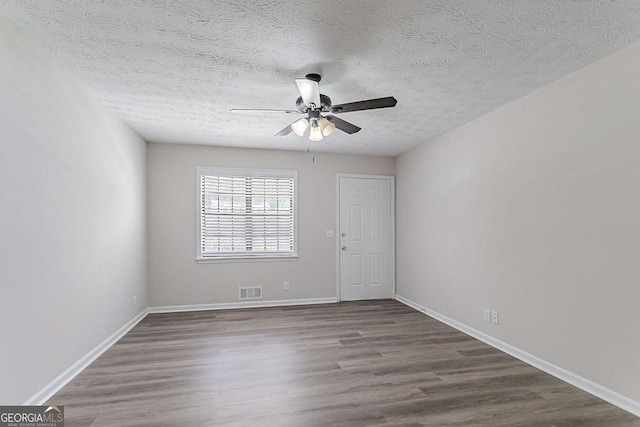 842 Brighton Dr, Lawrenceville, GA 30043 - empty room with ceiling fan, baseboards, wood finished floors, and a textured ceiling