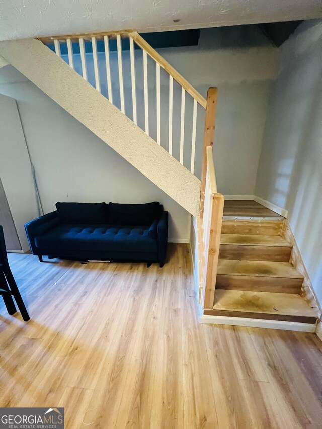 stairs featuring baseboards and wood finished floors