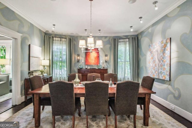dining space featuring wood finished floors, a wealth of natural light, and crown molding