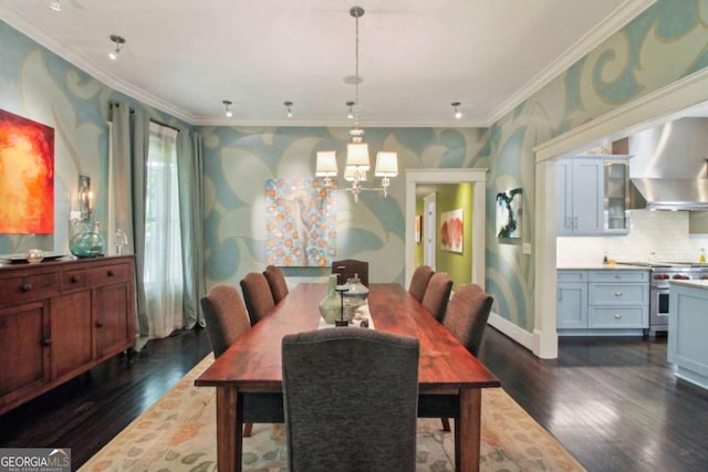 dining room with dark wood finished floors, crown molding, and a chandelier