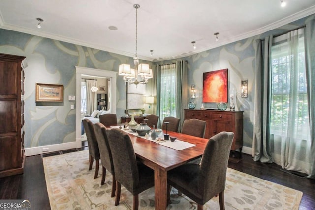 dining space featuring crown molding, a notable chandelier, wood finished floors, and a healthy amount of sunlight