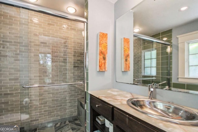 full bath featuring recessed lighting, vanity, and a stall shower