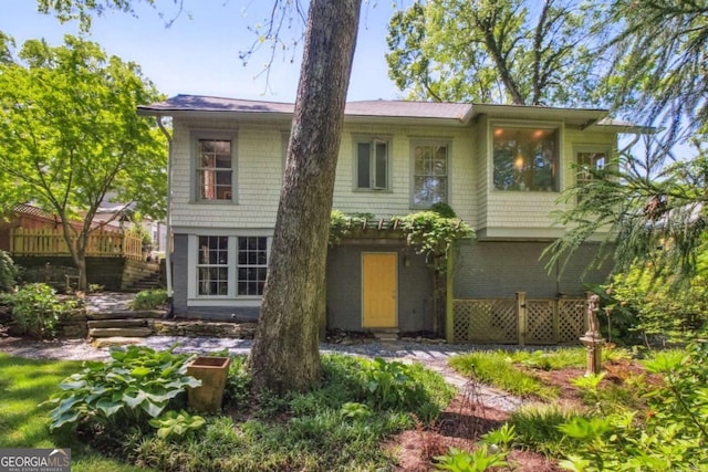 rear view of property featuring brick siding