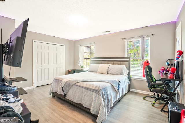 384 Parc River Blvd, Lawrenceville, GA 30046 - bedroom with multiple windows, baseboards, and light wood-style floors