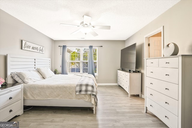 384 Parc River Blvd, Lawrenceville, GA 30046 - bedroom featuring a textured ceiling, light wood-style flooring, ceiling fan, and baseboards