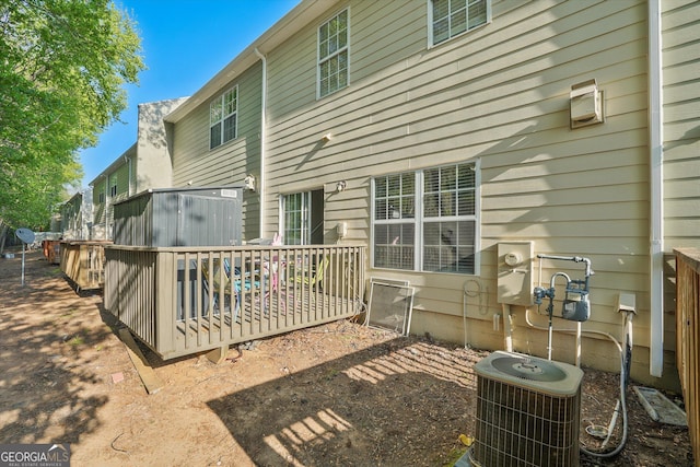 384 Parc River Blvd, Lawrenceville, GA 30046 - back of property with central AC and a wooden deck