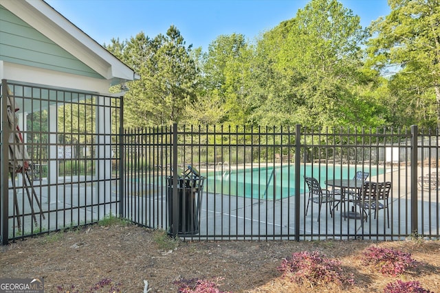 384 Parc River Blvd, Lawrenceville, GA 30046 - view of swimming pool with a patio area and view of wooded area