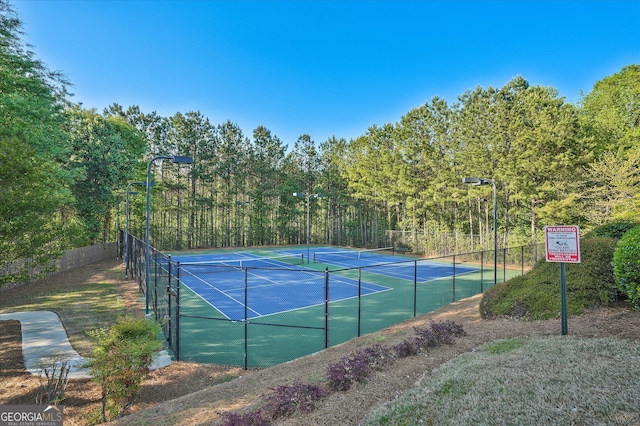 384 Parc River Blvd, Lawrenceville, GA 30046 - view of tennis court with a forest view