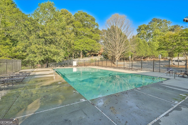 384 Parc River Blvd, Lawrenceville, GA 30046 - community pool with a patio area and view of wooded area