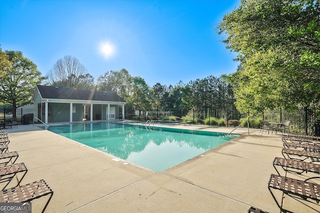 384 Parc River Blvd, Lawrenceville, GA 30046 - community pool with a patio area and view of wooded area