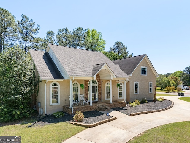 207 Jamestown Ave, Jonesboro, GA 30236 - view of front facade featuring a porch, stucco siding, a front lawn, a shingled roof, and driveway