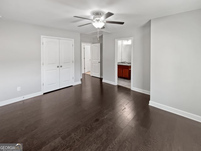 2470 Bridle Bridge Trl, Cumming, GA 30040 - interior space featuring dark wood finished floors, a ceiling fan, a sink, a closet, and baseboards