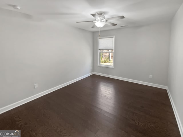 2470 Bridle Bridge Trl, Cumming, GA 30040 - spare room with dark wood-style flooring, visible vents, baseboards, and ceiling fan