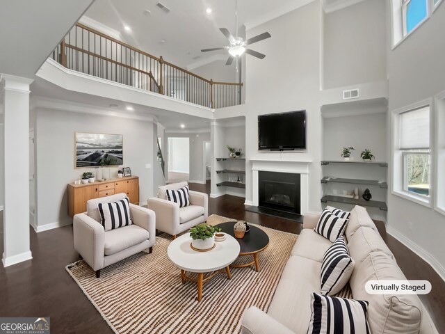 2470 Bridle Bridge Trl, Cumming, GA 30040 - living area featuring wood finished floors, a high ceiling, ceiling fan, and visible vents