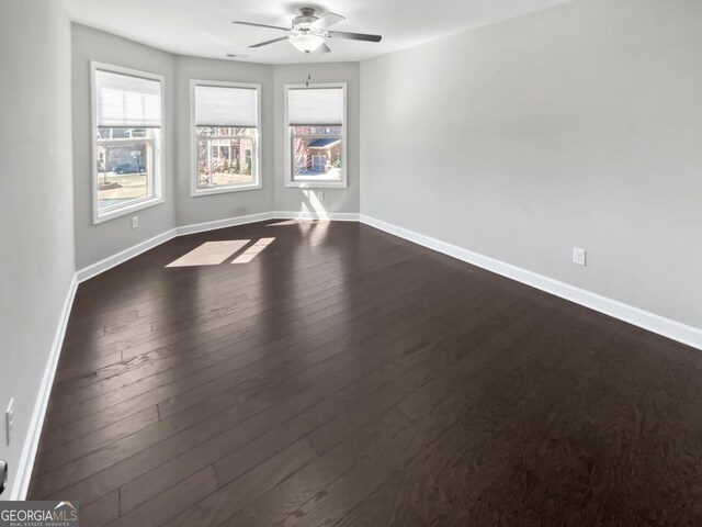 2470 Bridle Bridge Trl, Cumming, GA 30040 - empty room featuring baseboards, ceiling fan, and a healthy amount of sunlight