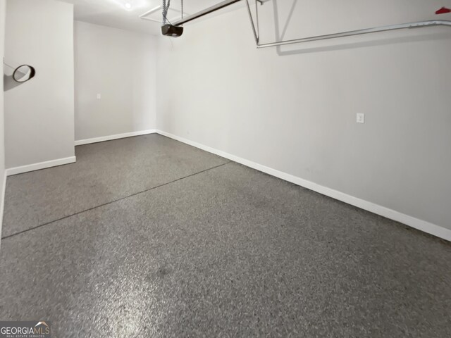 2470 Bridle Bridge Trl, Cumming, GA 30040 - garage with a garage door opener and baseboards