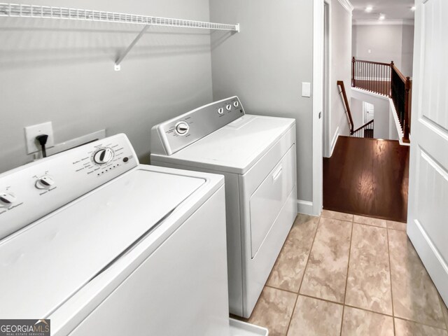 2470 Bridle Bridge Trl, Cumming, GA 30040 - washroom featuring washing machine and dryer, light tile patterned floors, and laundry area