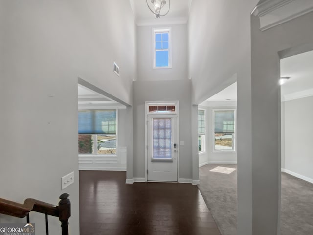 2470 Bridle Bridge Trl, Cumming, GA 30040 - foyer entrance featuring hardwood / wood-style floors, a high ceiling, visible vents, ornamental molding, and baseboards